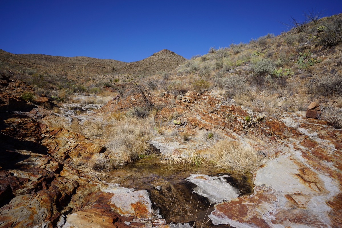 elephant tusk trail water flowing through red rock wash