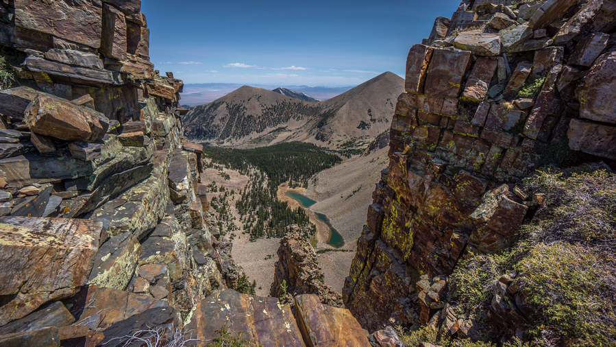 hikers view though the window over baker lake along the snake range ridgeline