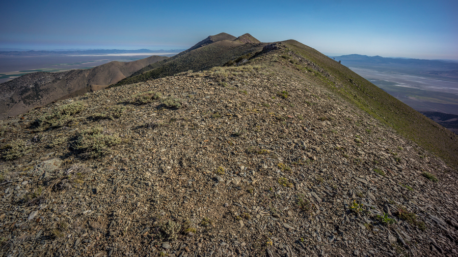 hiker walks the crest of the diamond range in nevada