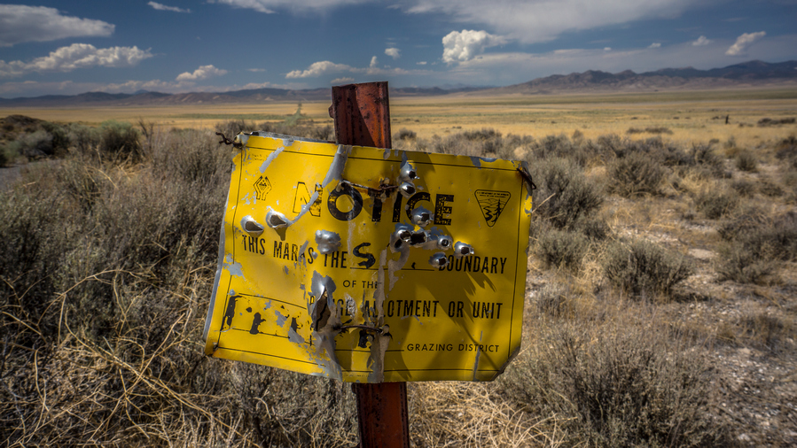 metal sign with bullet holes in nevada wilderness