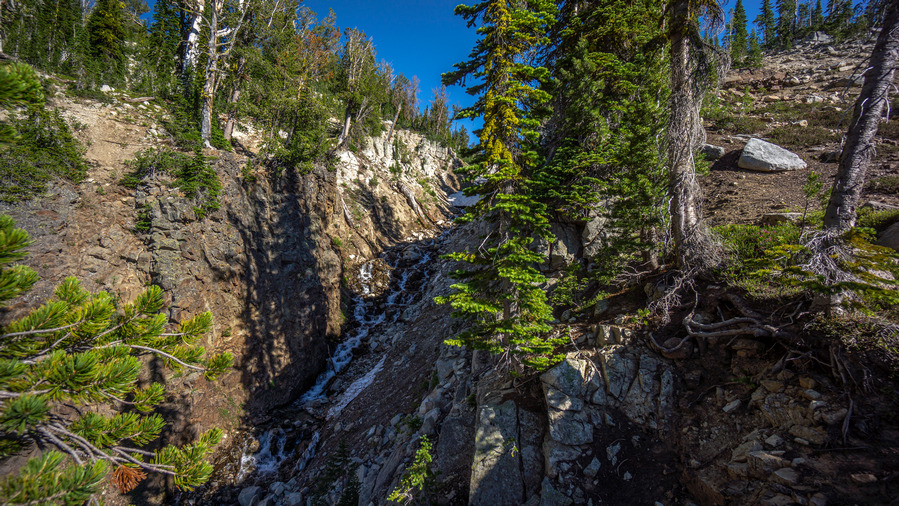 hiking up glacier pass in wallowa mountains long couloir filled with snow and water