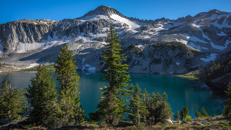 hikers view of turquoise blue glacier lake in wallowa mountains 