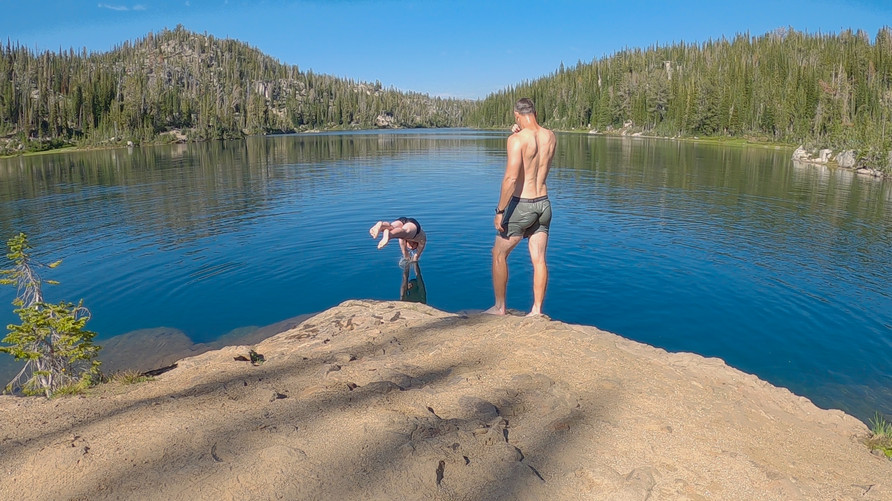 hikers dive and swim in moccasin lake, wallowa mountains, oregon