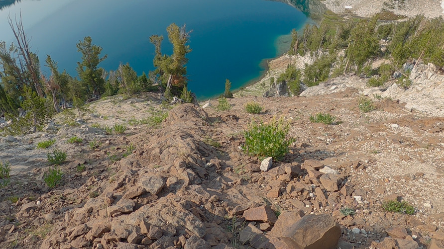 view down into alpine lake from hike across steep talus slope in wallowa mountains oregon