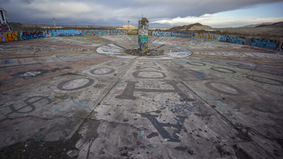 circular concrete structure at abandoned mine painted to represent the wheel of fortune, but every spin is a loser