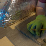 Chevy Astro Camper Van Build: Measuring vinyl plank floor during installation