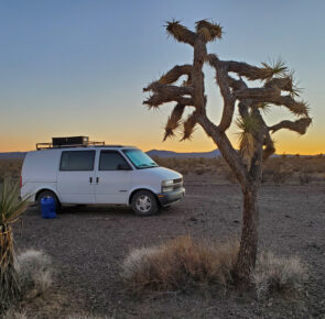 van life campsite in the mojave desert joshua tree at sunset