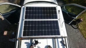 installing 2 100w solar panels on the roof of a astro safari van